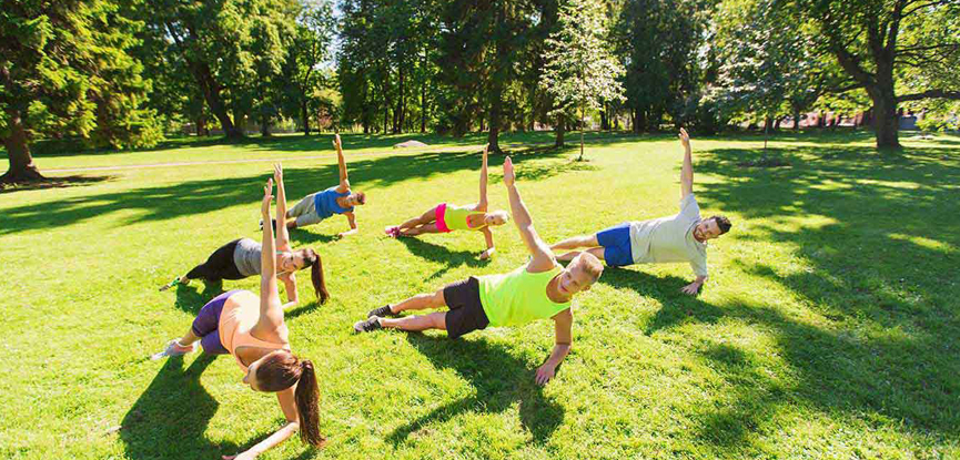 A group taking part in an outdoor fitness class
