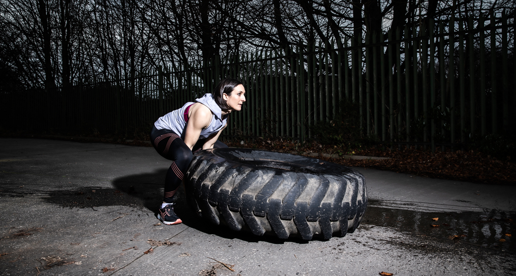 Personal training graduate Laura McNally flipping a tyre