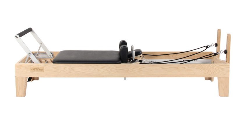 A typical wooden and metal Pilates reformer